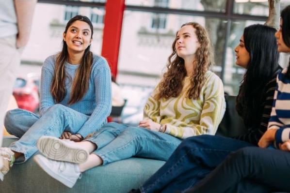 students sitting around a table chatting